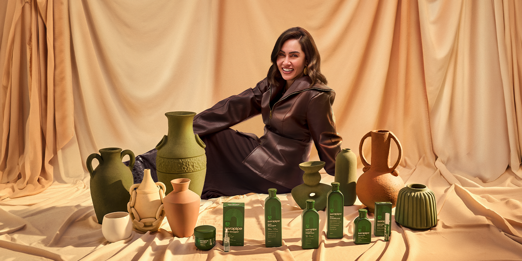Woman posing with seropipe hair care products.