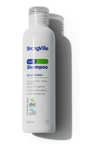 A bottle of Strongville Extra Hair Shampoo, 220 ml in size, with label information indicating it is a hair bond builder and hair growth regulator.